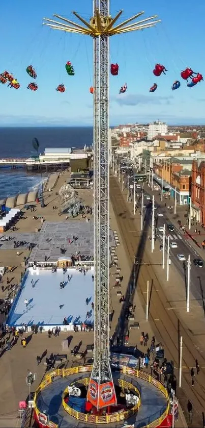 Aerial view of seaside amusement ride with vibrant blue sky.