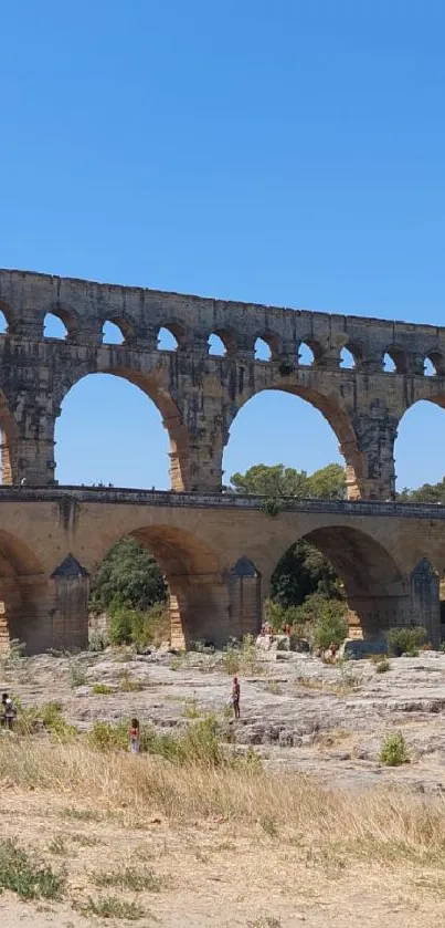 Ancient stone bridge against a clear blue sky.