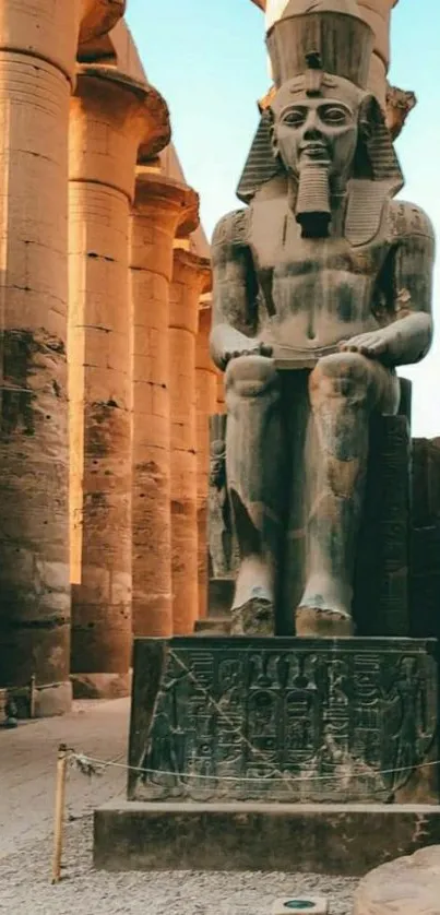 Ancient Egyptian statue with columns in background.