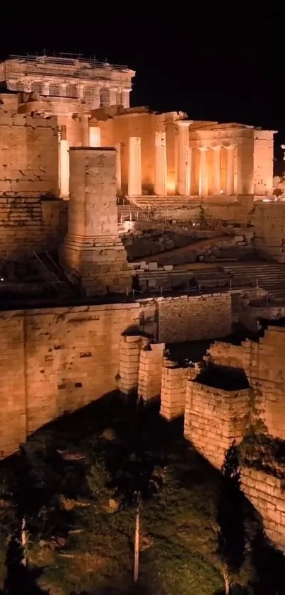 Illuminated ancient Greek ruins at night.