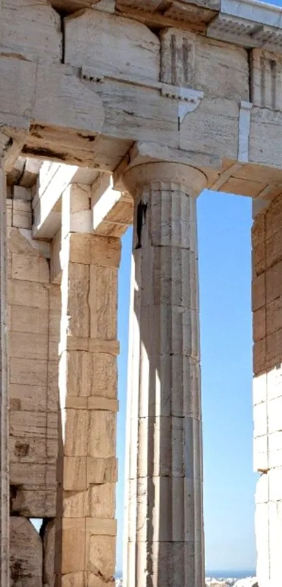 Greek temple columns against a blue sky.