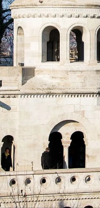 Stone building with elegant arches and windows, showcasing classic architecture.