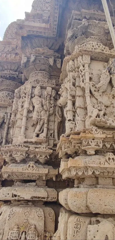 Intricate beige stone temple carvings in ancient architecture.