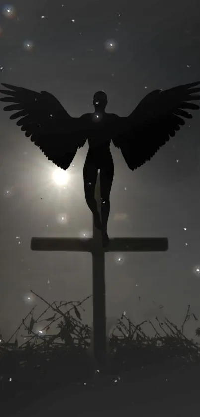 Silhouette of angel over cross against starlit dark gray sky.