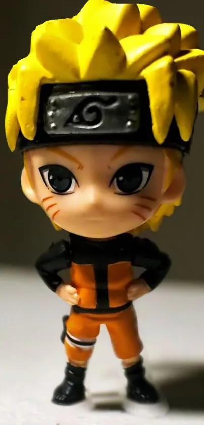 Anime figurine in orange suit with yellow spiky hair standing confidently.