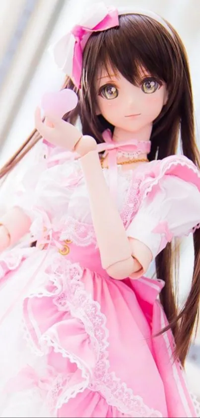 Anime doll wearing a pink dress with a heart accessory.