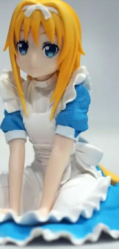 Anime figure in blue and white dress with blonde hair, sitting gracefully.