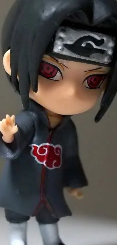 Anime figurine with dark hair and red eyes in detailed attire.