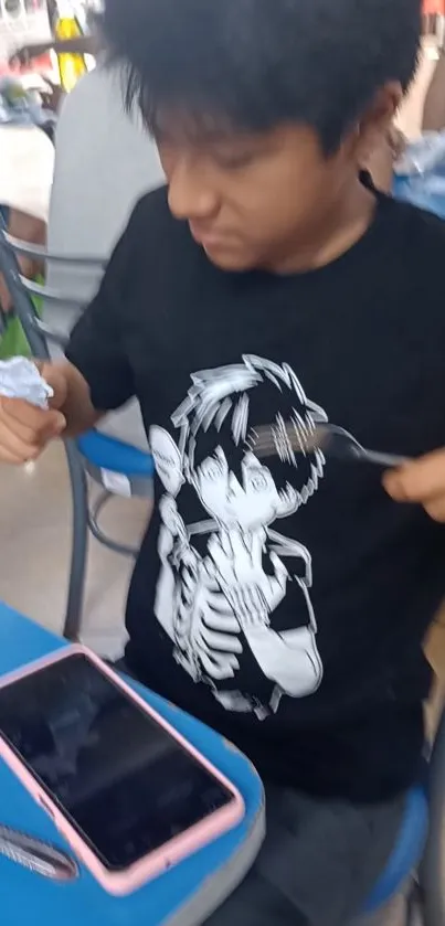 Person wearing anime-themed shirt dining casually.