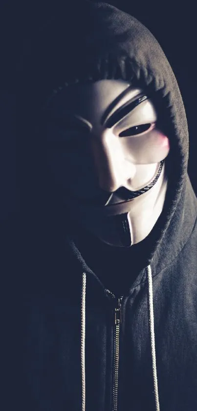 Dark themed wallpaper with an anonymous mask and hooded figure.