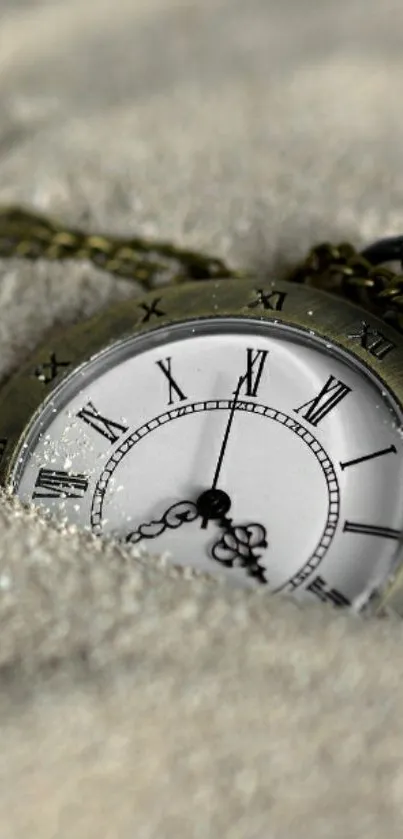 Antique pocket watch buried in sand, showcasing timeless elegance.