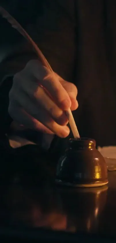 A hand holds a quill over an inkwell on a dark desk.