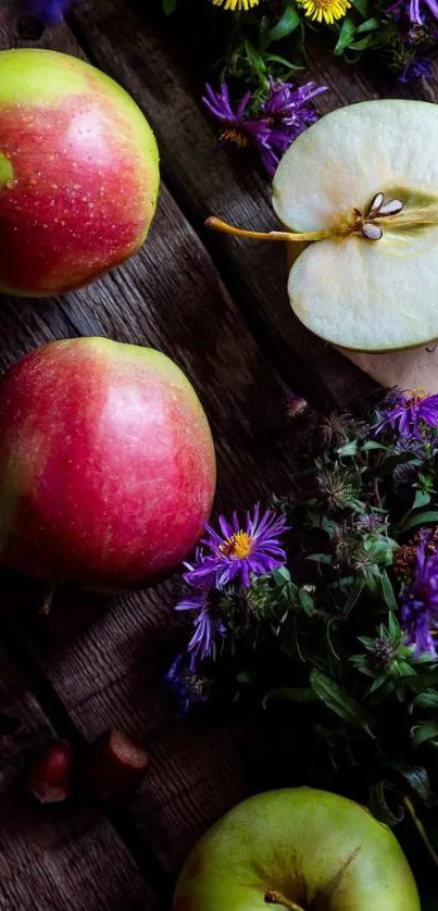 Apples and wildflowers on rustic wood table.