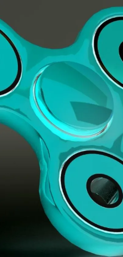 Turquoise fidget spinner on a dark background.