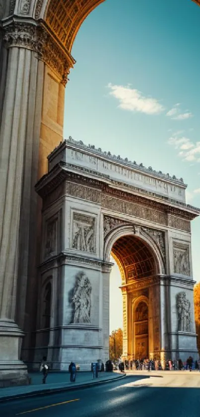 Arc de Triomphe with morning light against a clear blue sky.