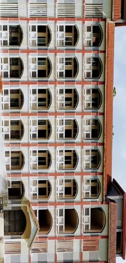 Photo of a beige and red multi-story building exterior.