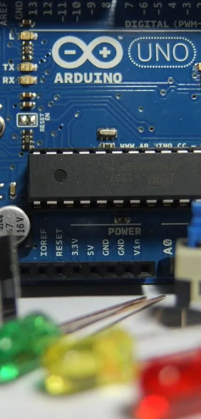 Close-up view of Arduino Uno circuit board, featuring microcontroller and components.