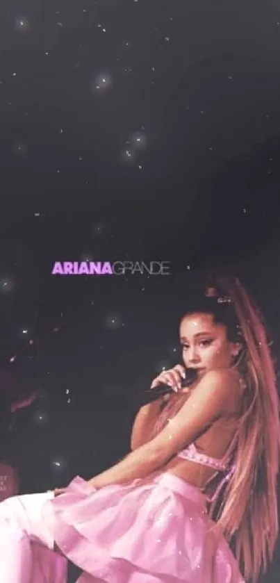 Ariana Grande in pink outfit against black starry background.