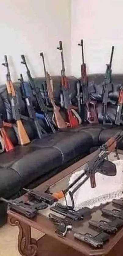 Wallpaper with multiple rifles and handguns displayed on a couch and table.