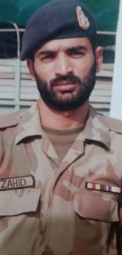 Soldier in olive green uniform, serious expression.