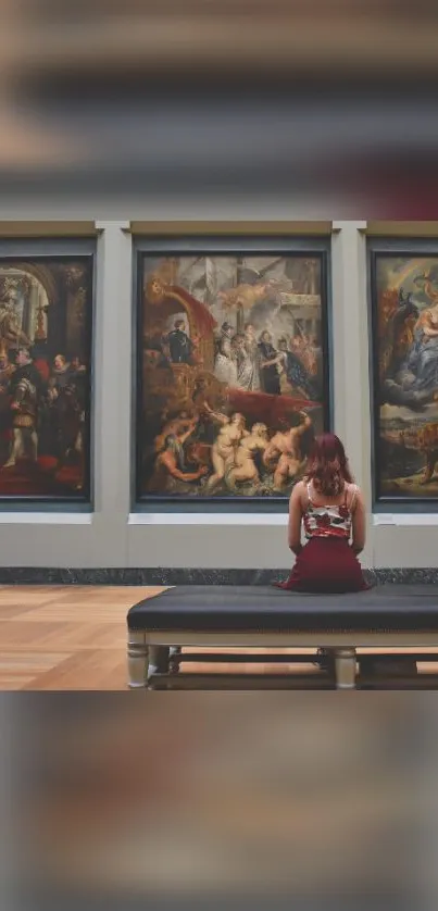 Woman sitting in art gallery viewing paintings