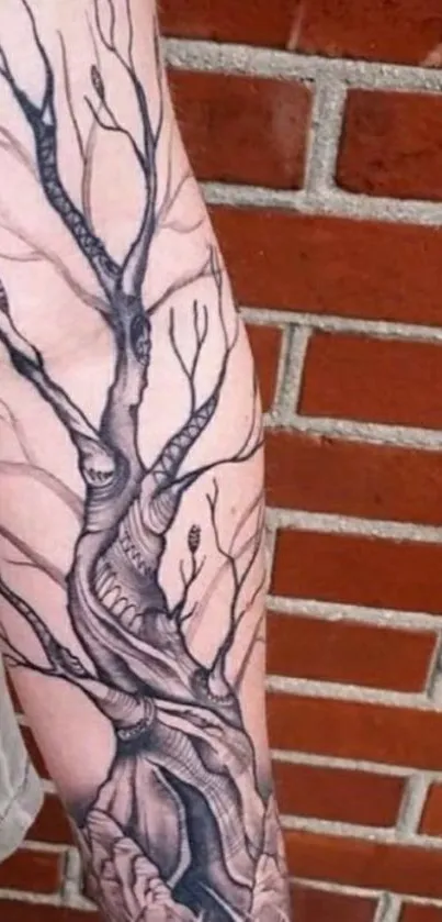 Arm tattoo of a tree against a brick wall.