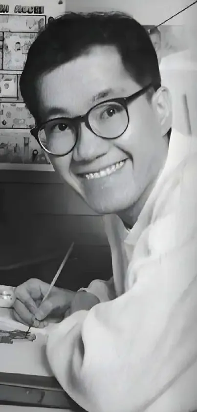 Black and white portrait of a smiling artist painting.