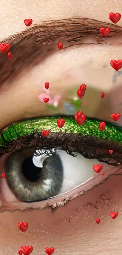 Close-up eye with green eyeliner and red hearts.