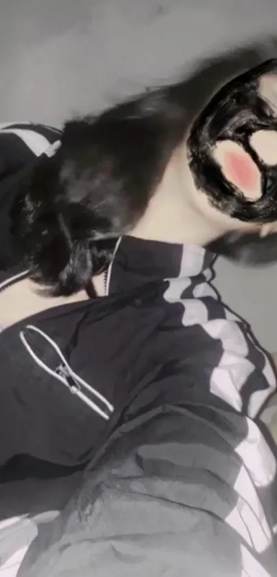 Portrait with dark artistic mask on phone wallpaper.