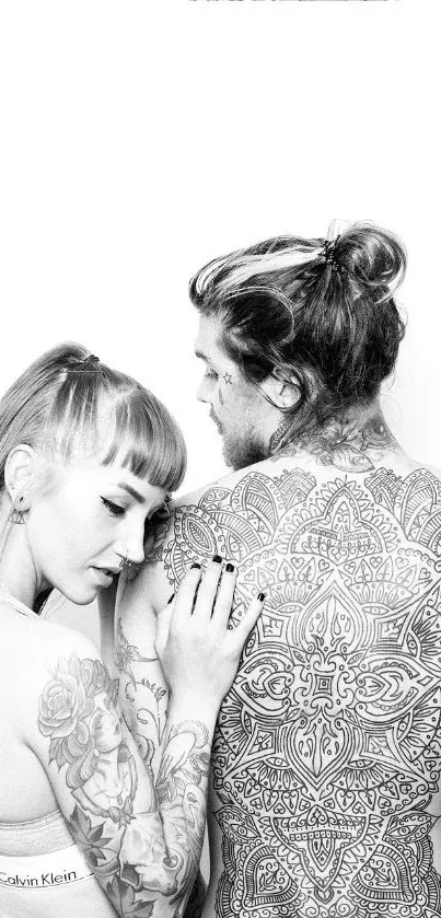 A black and white wallpaper featuring a tattooed couple in an artistic pose.