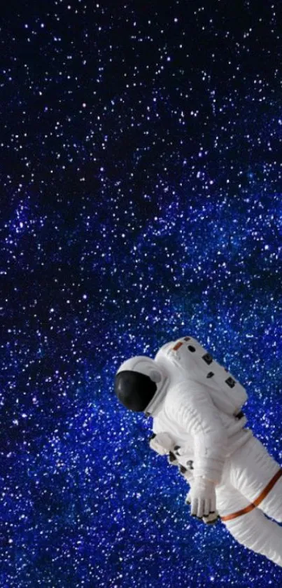 Astronaut floating in deep blue starry galaxy wallpaper.