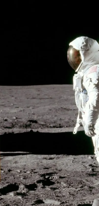 Astronaut standing on moon with American flag.