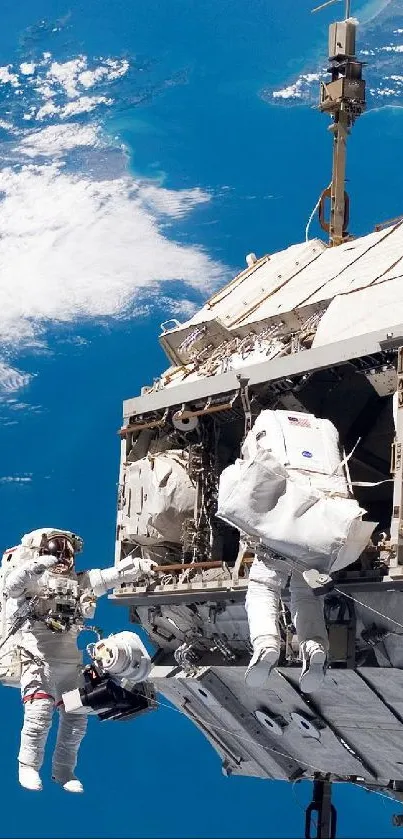 Astronauts on a spacewalk outside the space station with Earth in view.
