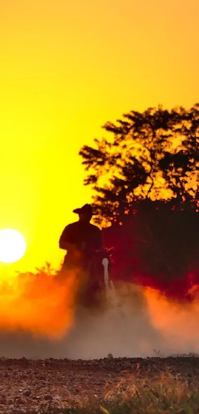 Silhouetted ATV riders at sunset with vibrant orange hues.