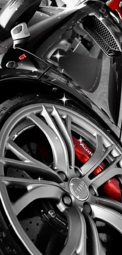 Close-up of a black Audi sports car wheel with red brake calipers.