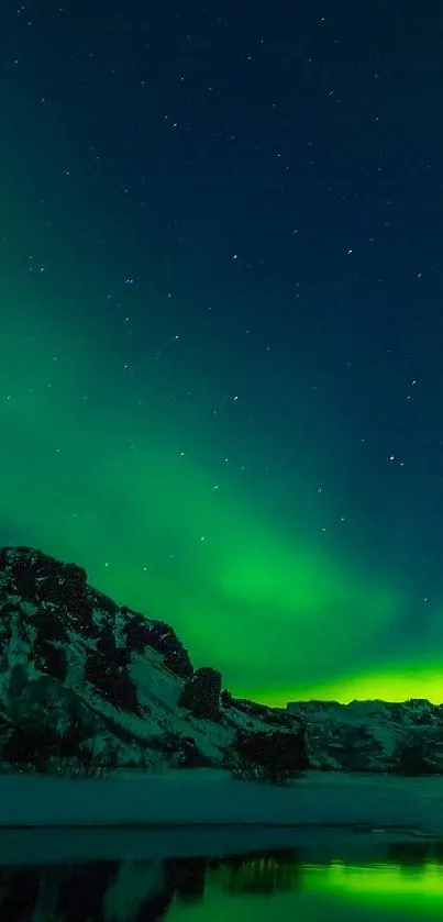 Northern lights over snowy mountains with a vibrant green glow.