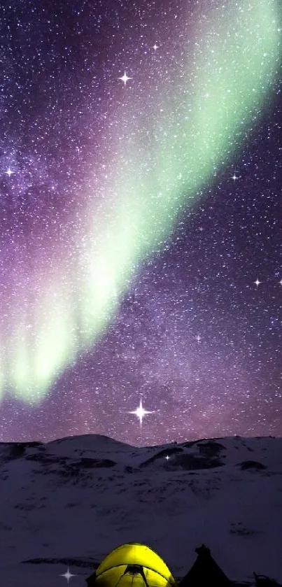 Aurora Borealis illuminating a tent on a snowy mountain under a starry sky.