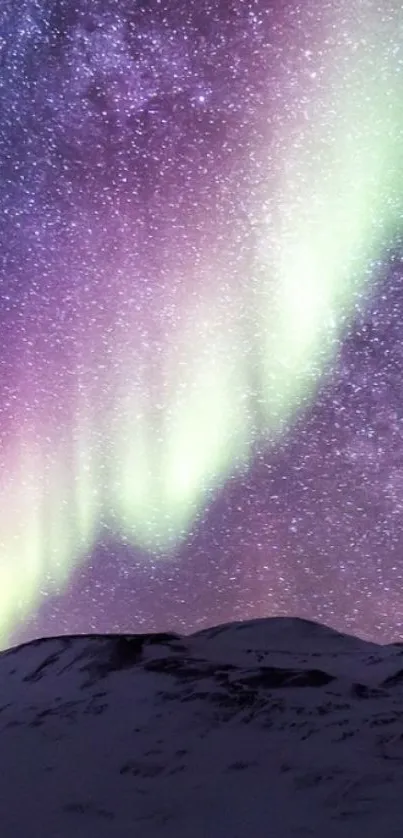 Colorful Aurora Borealis over a mountain with a tent below.