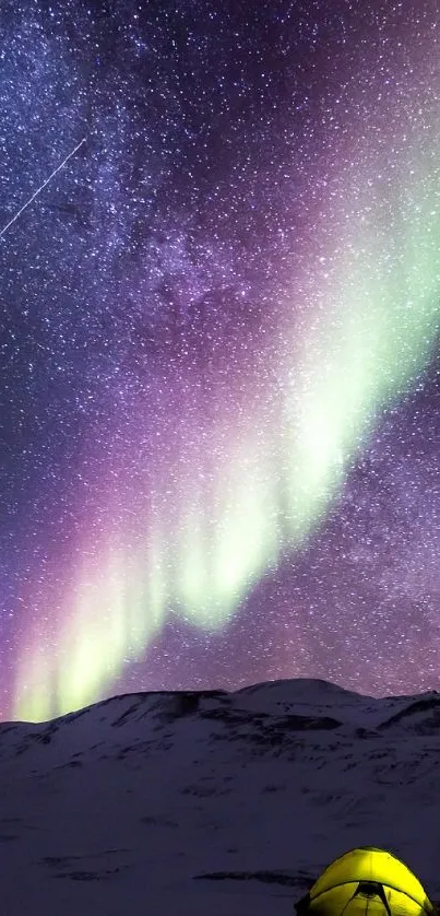 Northern Lights over snowy mountains with a starry night sky and a glowing tent.