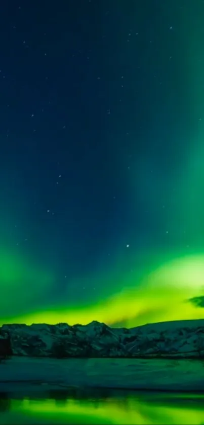 Aurora Borealis over mountains with vivid green hues in a starry night sky.