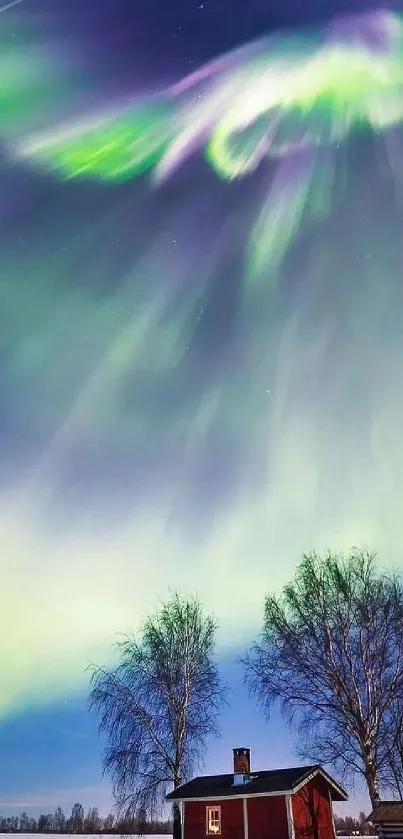 Aurora Borealis over a snowy landscape with a small cabin and trees.