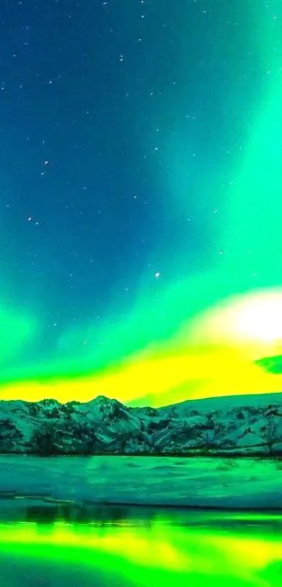 Vibrant green aurora over snowy mountains reflecting in a serene night landscape.