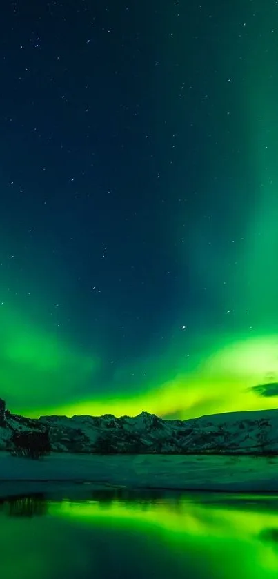Green aurora over snowy mountain landscape with starry sky.