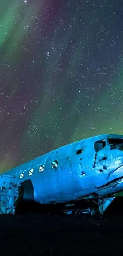 Aurora borealis lighting up wrecked plane under stars.