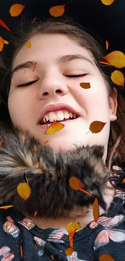 Smiling face surrounded by falling autumn leaves.