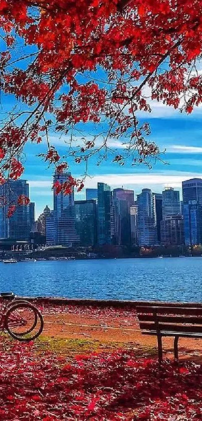 Mobile wallpaper of red autumn leaves framing a city skyline.