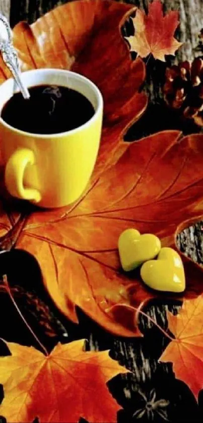 Yellow coffee cup on autumn leaves with a heart-shaped decoration.