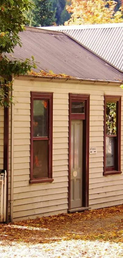 Charming autumn cottage surrounded by vibrant fall foliage.