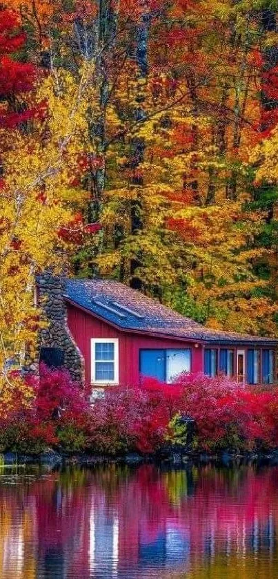 Red cabin by a lake amidst vibrant autumn forest scenery.