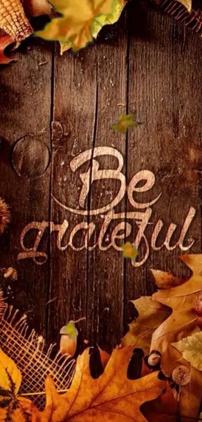 Rustic autumn wallpaper with 'Be Grateful' message and colorful fall leaves.